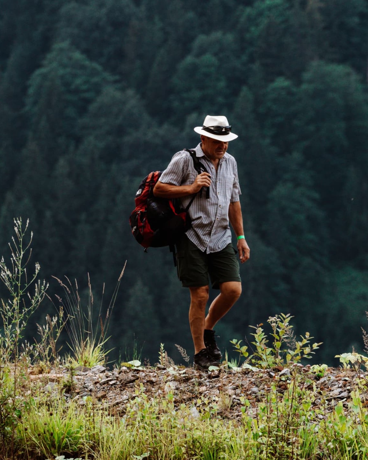 Man in his fifties hiking confidently in the mountains